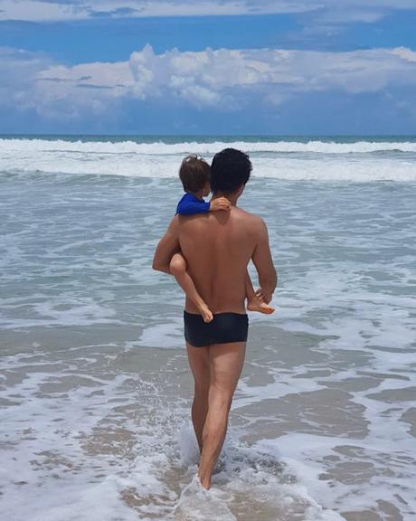 Romulo Estrela com o filho na praia