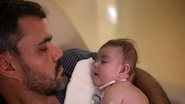O ator Juliano Cazarré segurando sua filha caçula, Maria Guilhermina, no colo - Foto: Reprodução/Instagram @cazarre