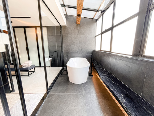 O banheiro da suíte possui uma luxuosa banheira que é cercada de janelas, o que dá claridade ao cômodo. 