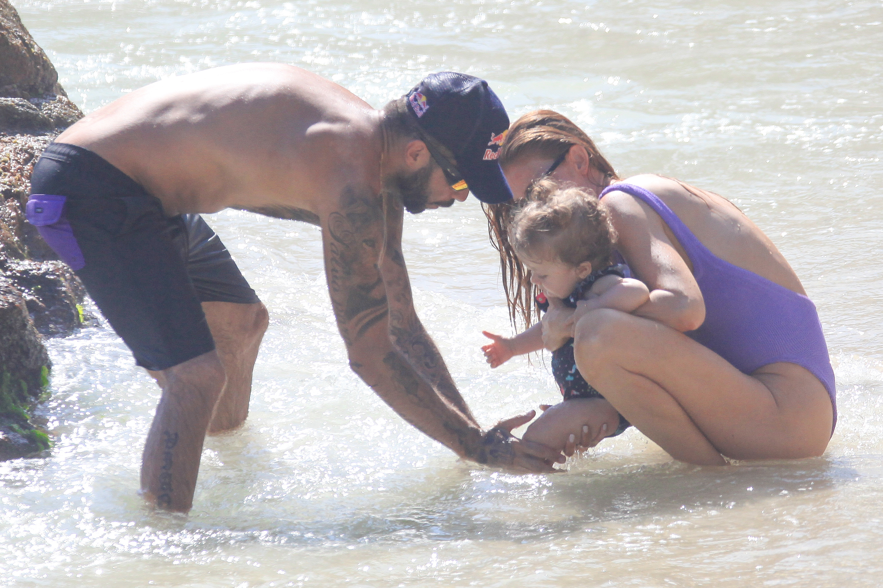 Pedro Scooby curte dia na praia com a filha e a esposa