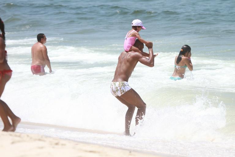 Leandrinho brinca com a filha Alicia na praia da Reserva