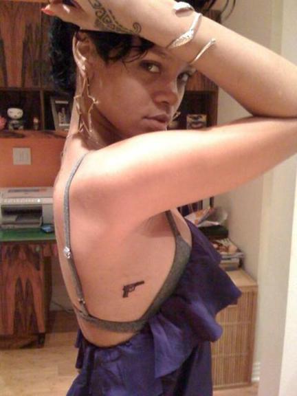 Rihanna desenhou a arma embaixo do braço em seu aniversário de 22 anos, após a briga com Chris Brown, em 2009