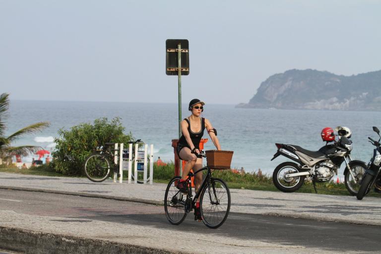 Christiane Torloni pedala pela orla da praia da Barra da Tijuca