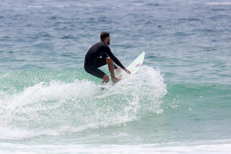 Cauã Reymond e José Loreto surfam em praias cariocas