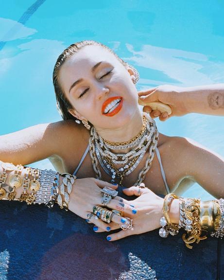 Luxo é pouco! Miley Cyrus posa com kilos de joias na piscina